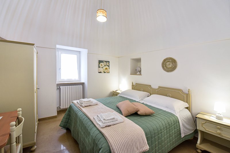 Original stone vaulted ceiling of the Trullo with double bed