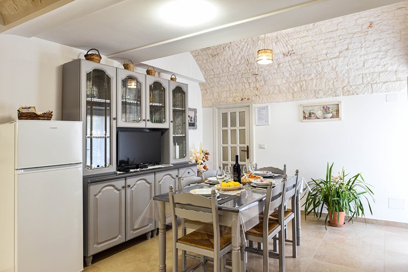 Living area with exposed stone walls and rustic furniture