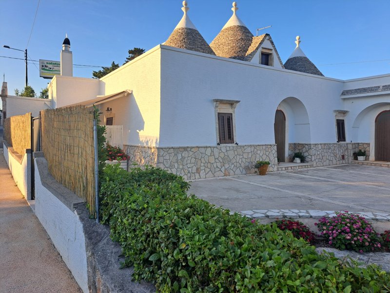 Suggestive view of the double cone trullo at sunset